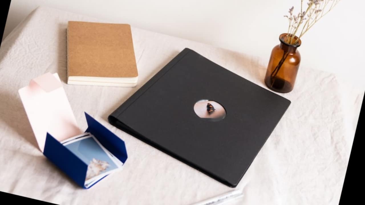 An open letter, a folder, and a diary sitting on a white tablecloth