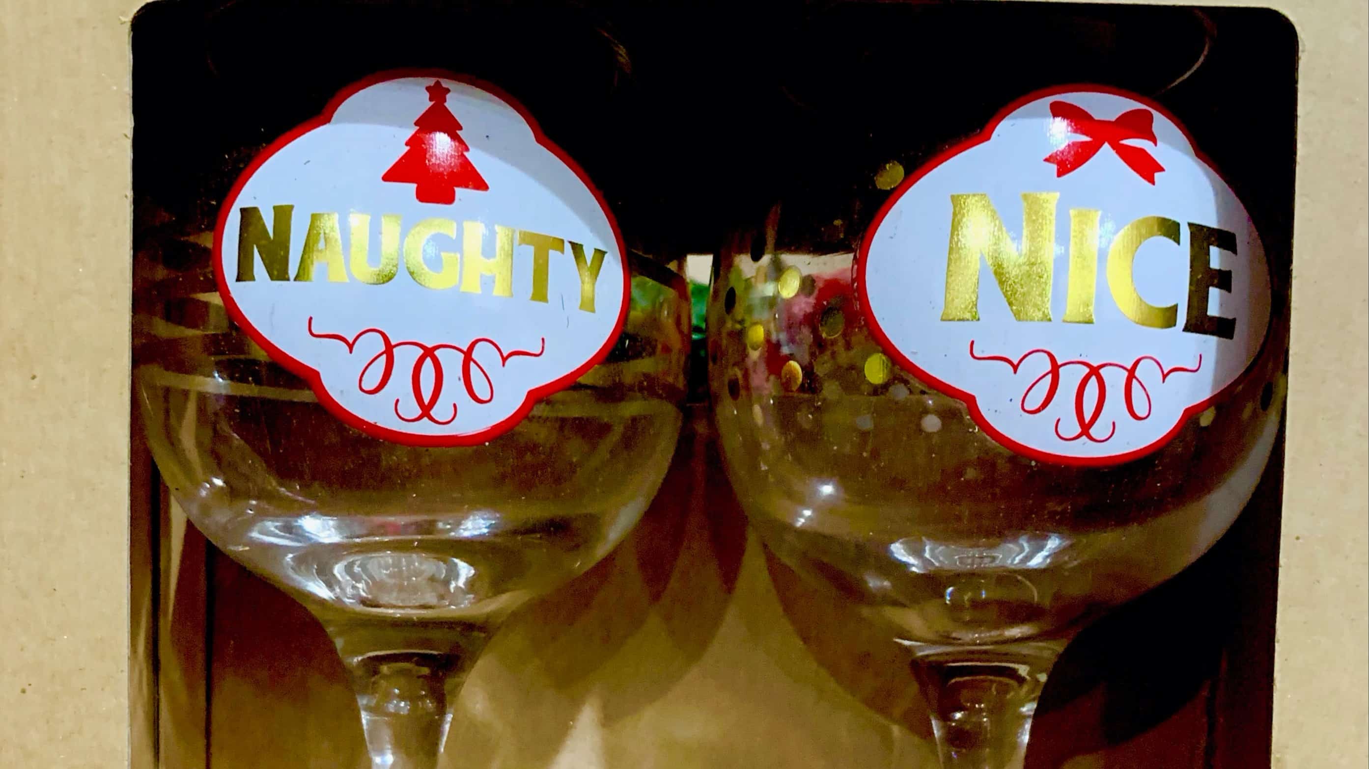 Two Party balloons with the words "naughty" and "nice" on each