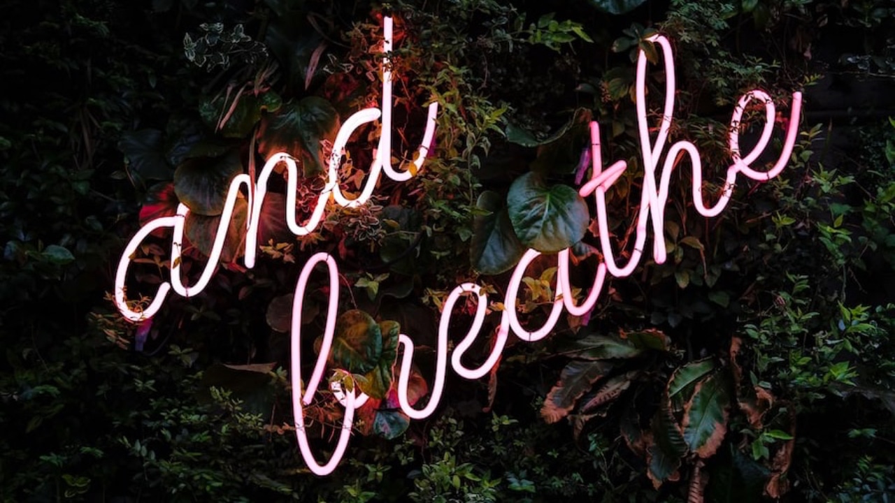 Neon light letters "and breathe "