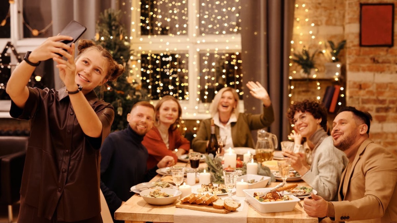 kid taking a selfie with his family at the Christmas table